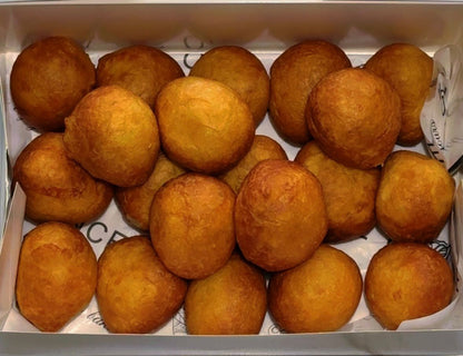 Box filled with golden brown fried puff-puff balls