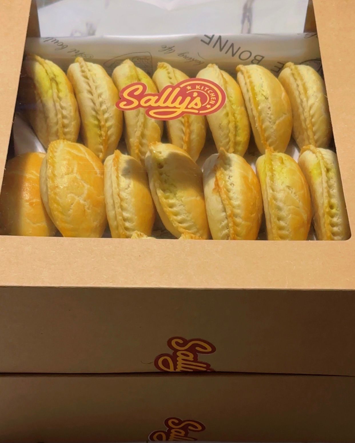 Box of meat pies with Sally's logo on a white background